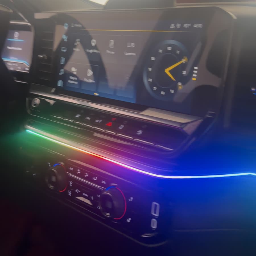 Truck dash with a color-changing ambient light strip under the screen