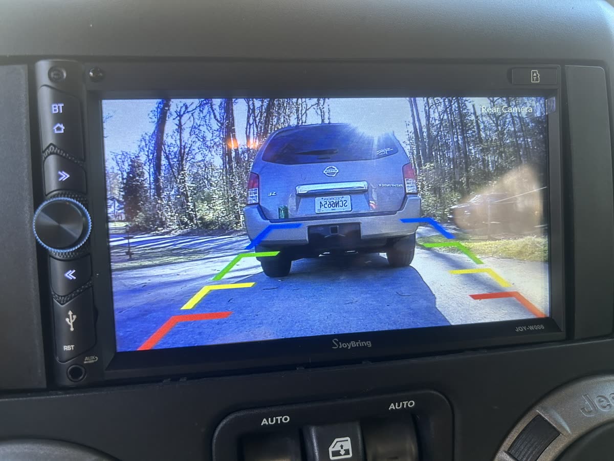 Jeep Wrangler touchscreen radio showing the backup camera view with guide lines